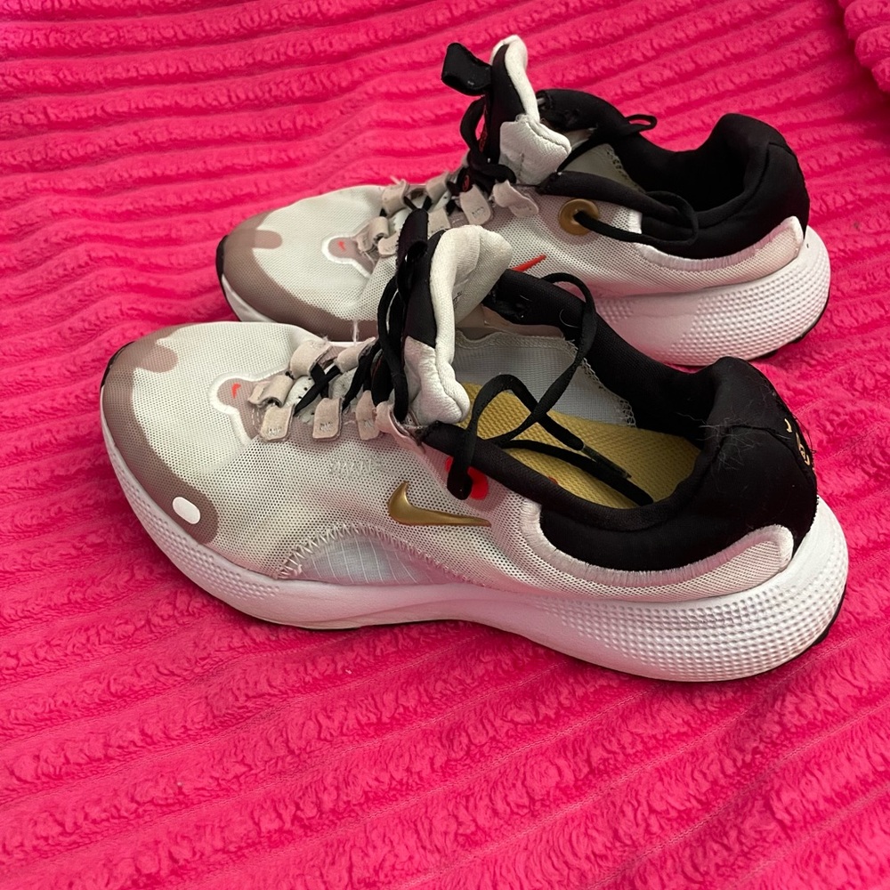 Nike White and Black Sneakers with Gold Swoosh